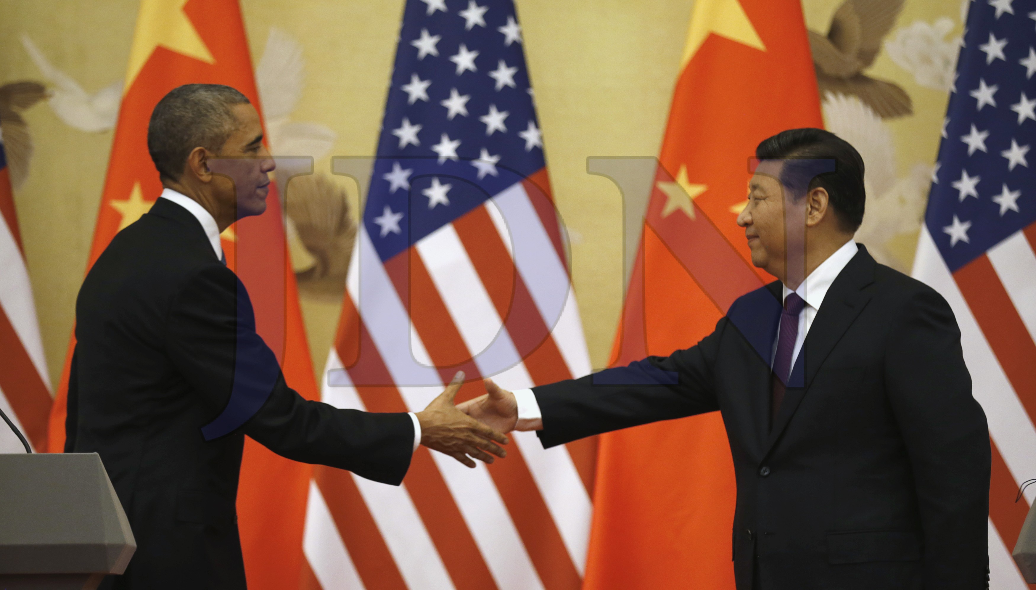 Obama and Xi shake hands at the end of their news conference in the Great Hall of the People in Beijing