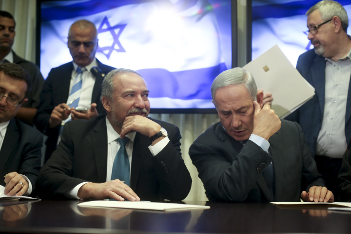 Israeli Prime Minister Benjamin Netanyahu and leader of the Israel Beyteinu political party Avigdor Liberman sign an agreement in the Israeli parliament on May 25, 2016, which will bring Israel Beyteinu into the coalition and name him defense minister. Photo by Yonatan Sindel/FLASH90 *** Local Caption *** ?????? ?????? ???? ??? ?????? ?????? ?????? ????