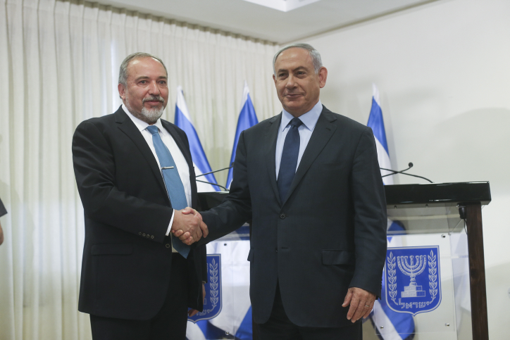 Israeli Prime Minister Benjamin Netanyahu and leader of the Israel Beyteinu political party Avigdor Liberman sign an agreement in the Israeli parliament on May 25, 2016, which will bring Israel Beyteinu into the coalition and name him defense minister. Photo by Yonatan Sindel/FLASH90 *** Local Caption *** ?????? ?????? ???? ??? ?????? ?????? ?????? ???? ????? ??