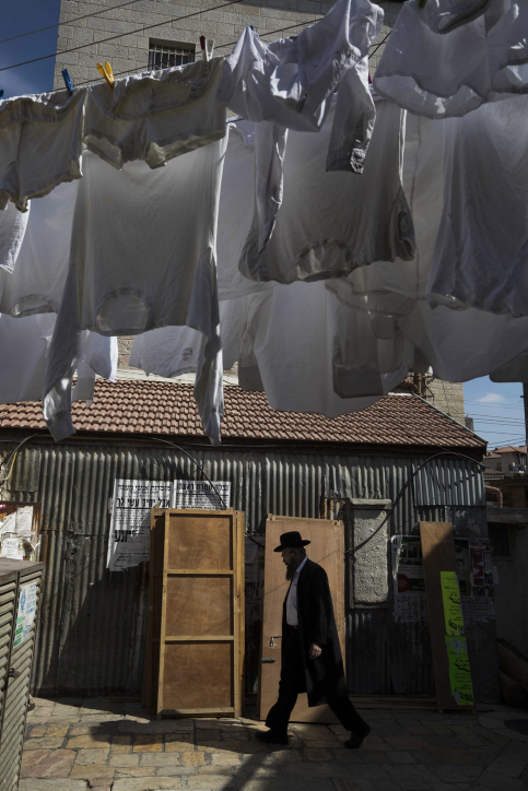 Ultra orthodox jews walk by a street full of "Sukkot" (temporary dwelling), in the religious neighborhood of Mea Shearim in Jerusalem on October 10, 2016. Sukkot commemorates the Israelites 40 years of wandering in the desert and a decorated hut or tabernacle (sukka) is erected outside religious households as a sign of temporary shelter. Photo by Nati Shohat/ FLASH90. *** Local Caption *** ???? ???? ????? ??? ????? ?????