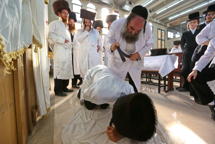An Ultra Orthodox Jewish man of the Hassidic Lelov dynasty whips another ultra orthodox Jewish man with a leather belt as a symbolic punishment for his sins during the traditional "Malkot" ceremony, a few hours before the start of Yom Kippur, the Jewish holy day of Atonement, in a synagogue in the town of Bet Shemesh, outside of Jerusalem. October 11, 2016. Photo by Yaakov Lederman / FLASH90 *** Local Caption *** ??? ????? ??? ??? ????? ????? ????