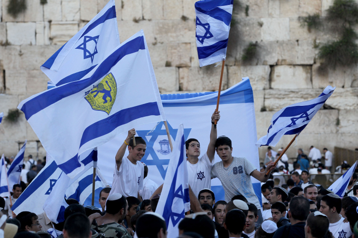 Israelis taking part in the annual flags parade as they celebrating Jerusalem Day in the streets of Jerusalem