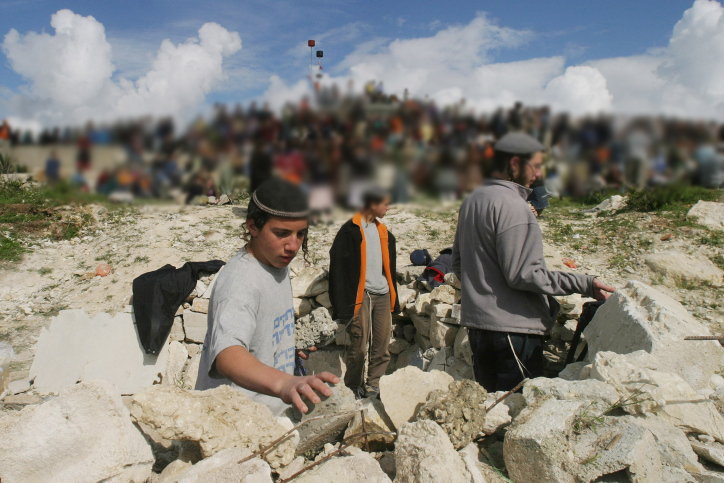 Israeli Jewish settlers protest in the evacuated settlement of Homesh, in the northern West Bank