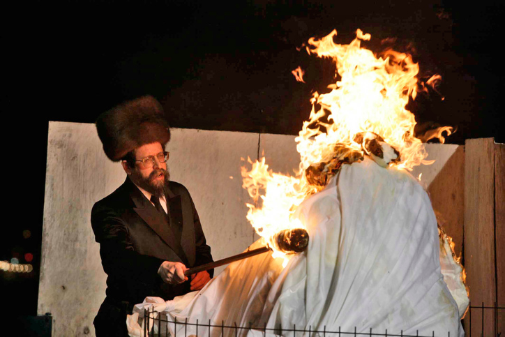 Ultra Orthodox Jew cuts the hair of three year old boy during the celebration of the Jewish holiday of Lag Baomer in Mt Meiron