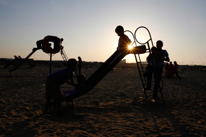 Palestinian children play at UN Cabarets the summer holidays a during sunset