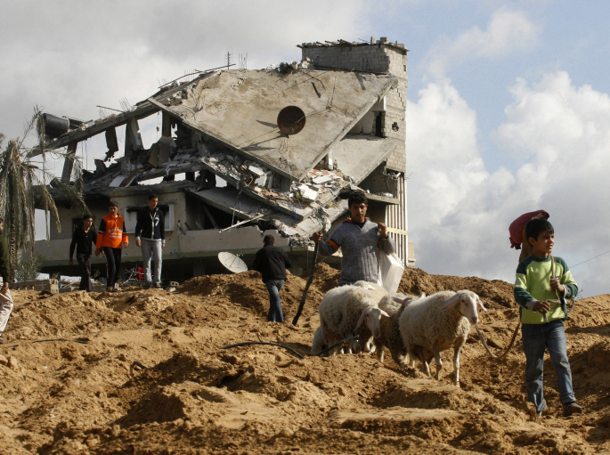 A Palestinian family inspects their homes