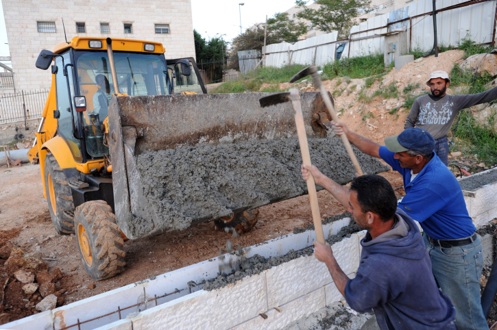 Palestinian construction workers are seen in a construction site in the east Jerusalem neighborhood of Ramat Shlomo