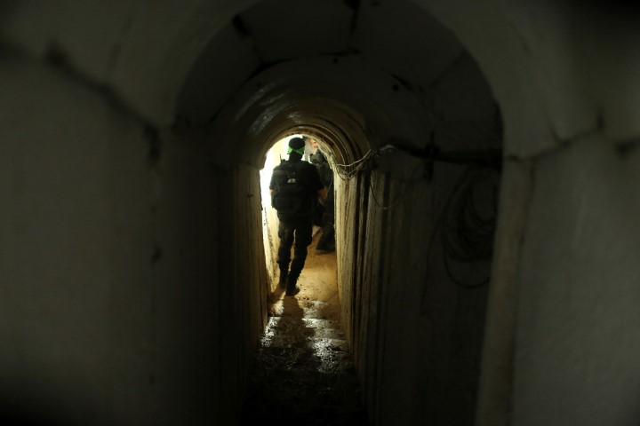 A Palestinian fighter from the Izz el-Deen al-Qassam Brigades, the armed wing of the Hamas movement, walks inside an underground tunnel in Gaza