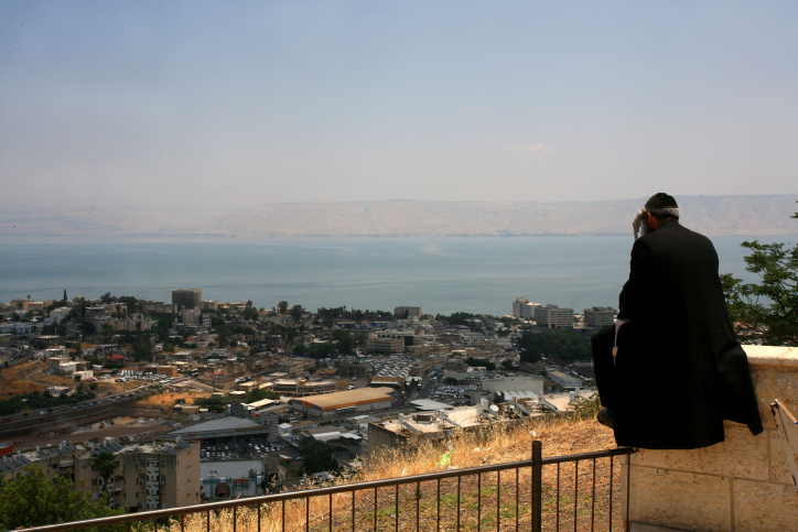 An Orthodox man watches the view of lake Kinneret at the burial place of Rabbi akiva