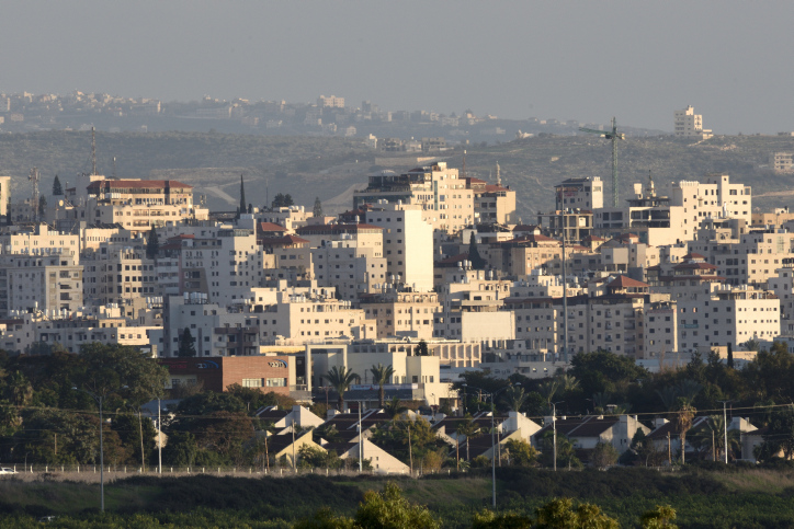 The Israeli Village Bat-hefer, located at Hefer Valley, backdropped by the Palestinian city Tulkarm