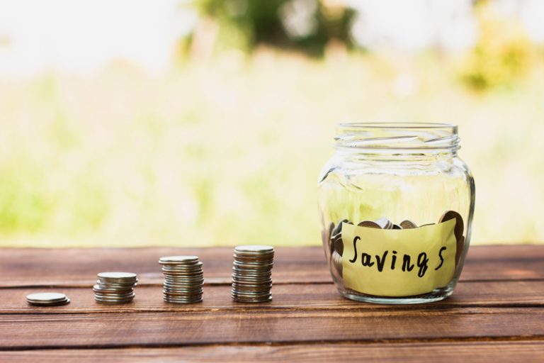jar-with-savings-coins-stack-table