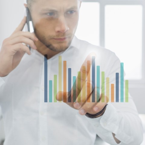businessman-doing-phone-call-looking-charts