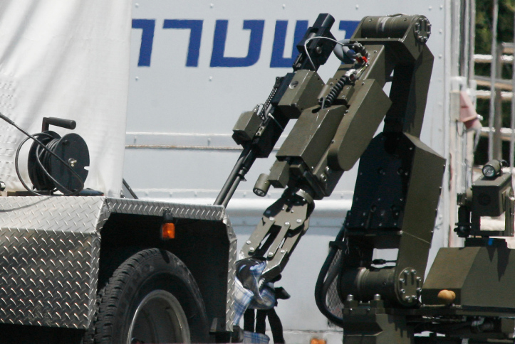 An Israeli bomb squad inspects the scene