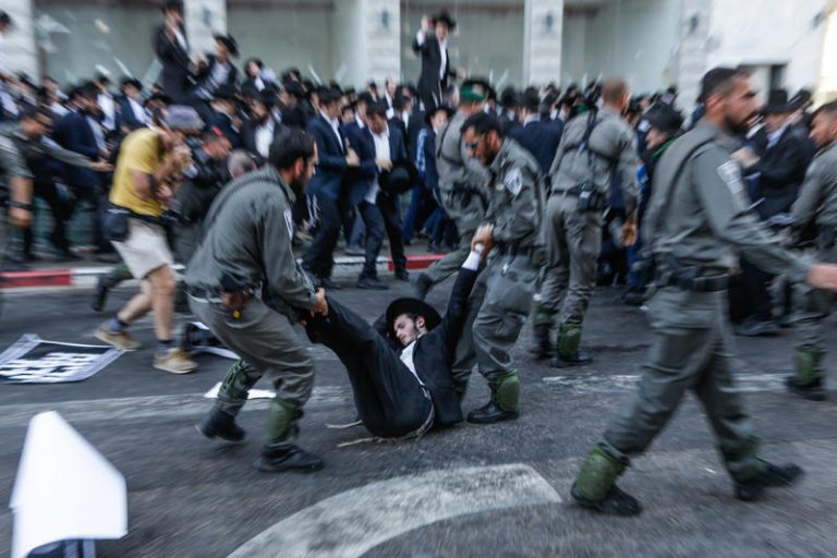 Ultra orthodox Jews clash with police as they protest against the arrest of ultra orthodox men who failed to show for their army draft in Bnei-Brak