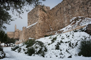 The Tower of David and the medieval stone walls of the Old City of Jerusaelm following a rare winter snowstorm in Israel