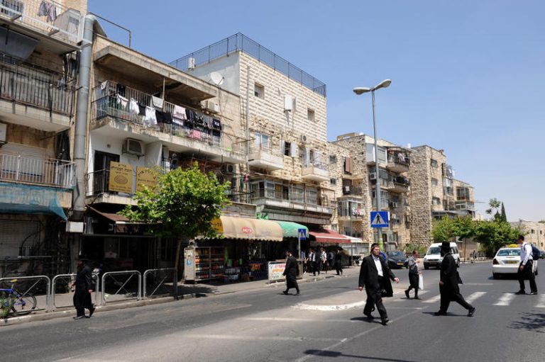 Ultra Orthodox Jewish men walk in a street at Shmuel Hanavi Ultra Orthodox Jewish neighborhood in Jerusalem