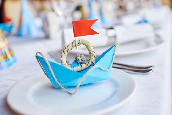 close-up-paper-boat-plate-table