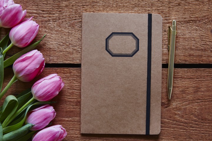 notebook and pen spring atmosphere with pink tulips