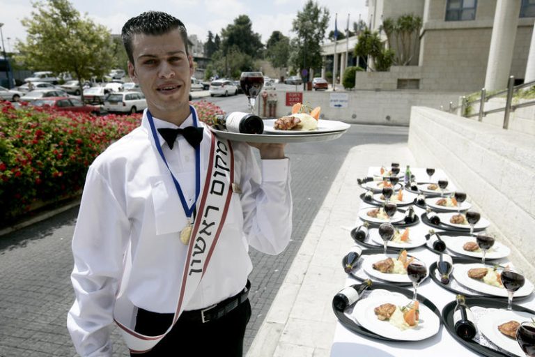 Waiters compete in a race in the Grand Court Hotel