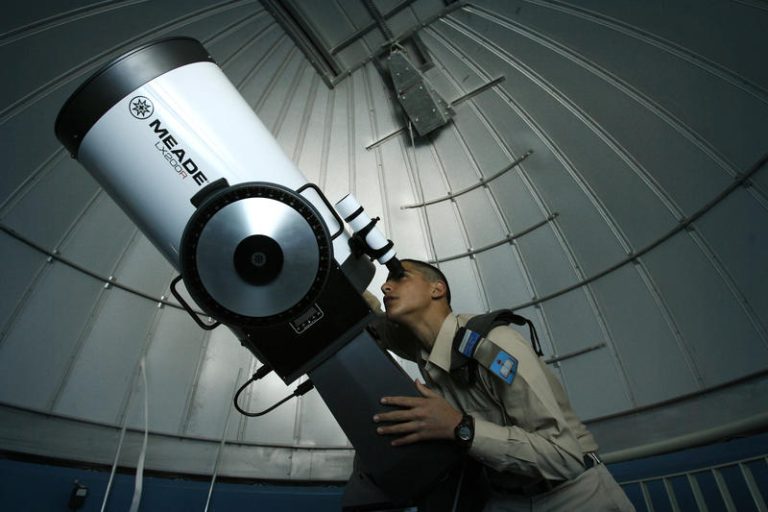 A student of an IDF air force school watches the stars through a telescope