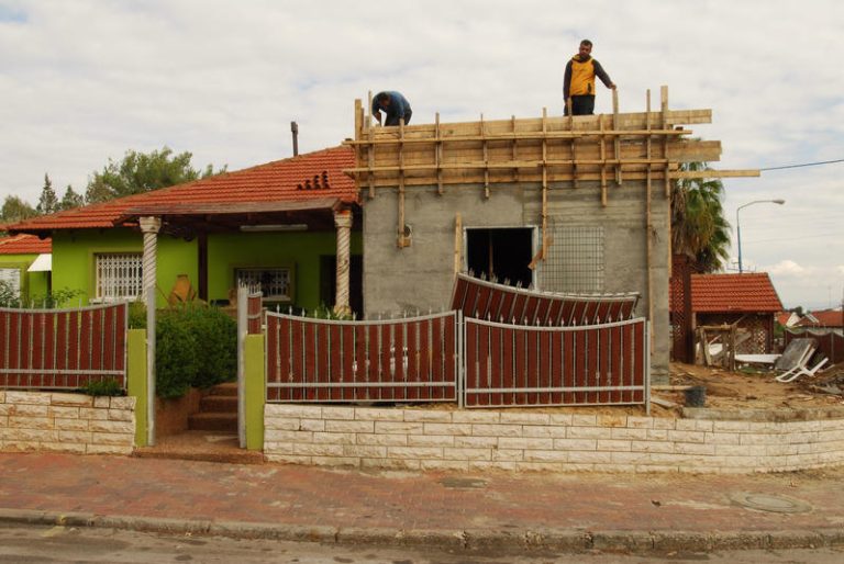 Construction workers are constructing a security room, which is a house internal bomb shelter in the Southern city of Sderot