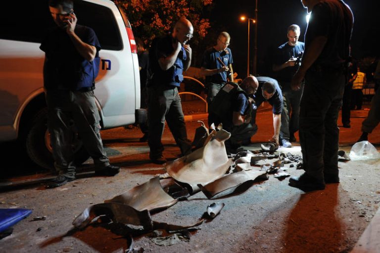 Bomb squad members are inspecting the remainings of the rocket which hit  a building in Rishon Letzion