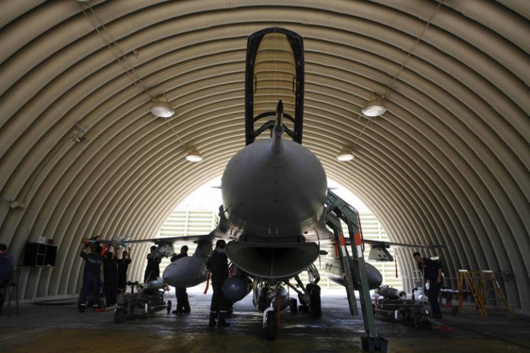 Israeli soldiers prepare an F-16 jet
