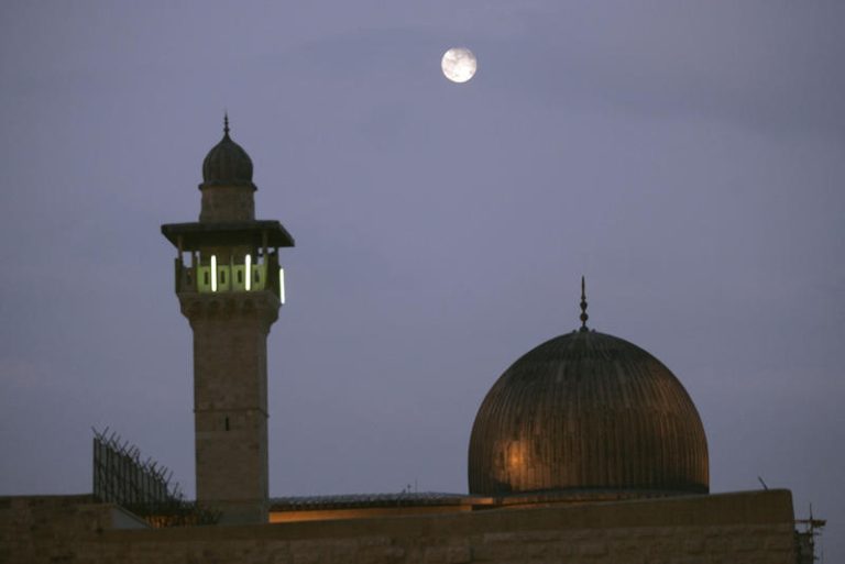 The full moon rises over Al-Aqsa Mosque