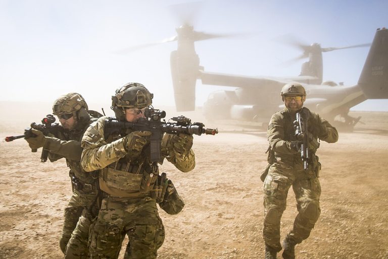 A_joint_special_forces_team_moves_together_out_of_an_Air_Force_CV-22_Osprey_aircraft,_Feb