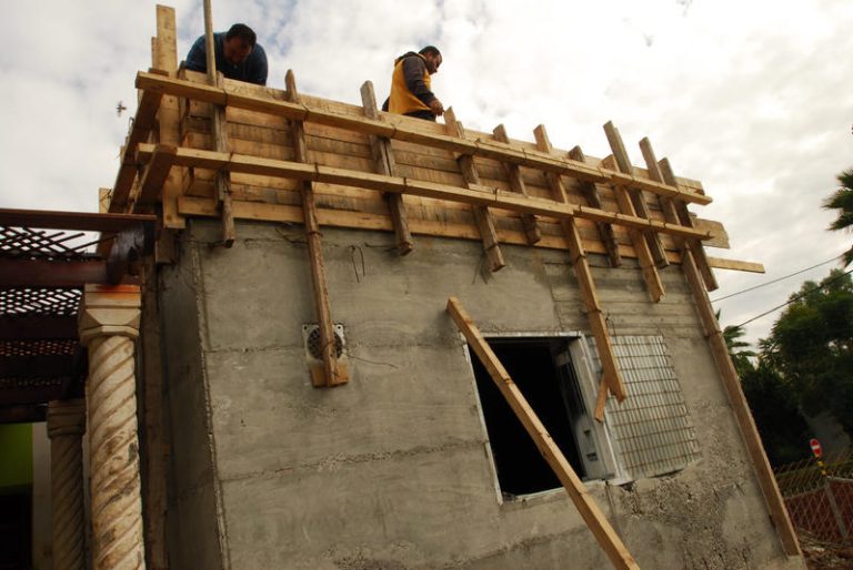 Construction workers are constructing a security room, which is a house internal bomb shelter in the Southern city of Sderot