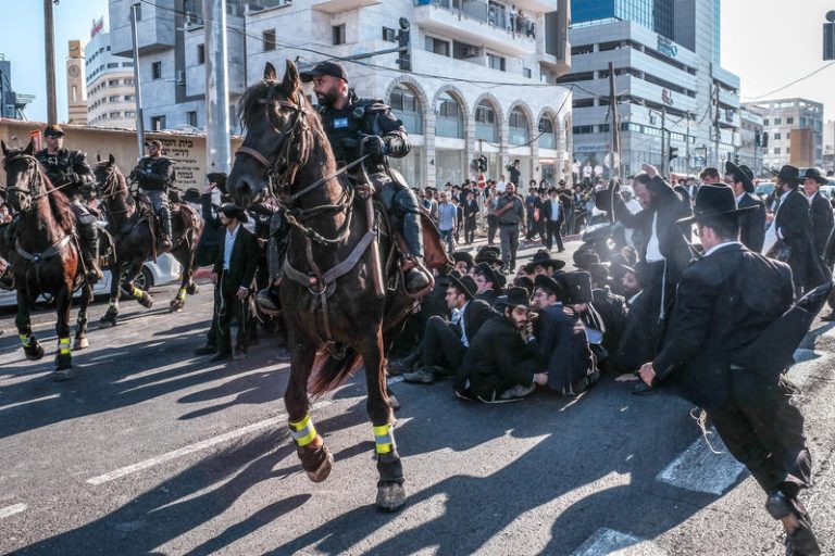 Ultra orthodox Jews clash with police as they protest against the arrest of ultra orthodox men who failed to show for their army draft in Bnei-Brak